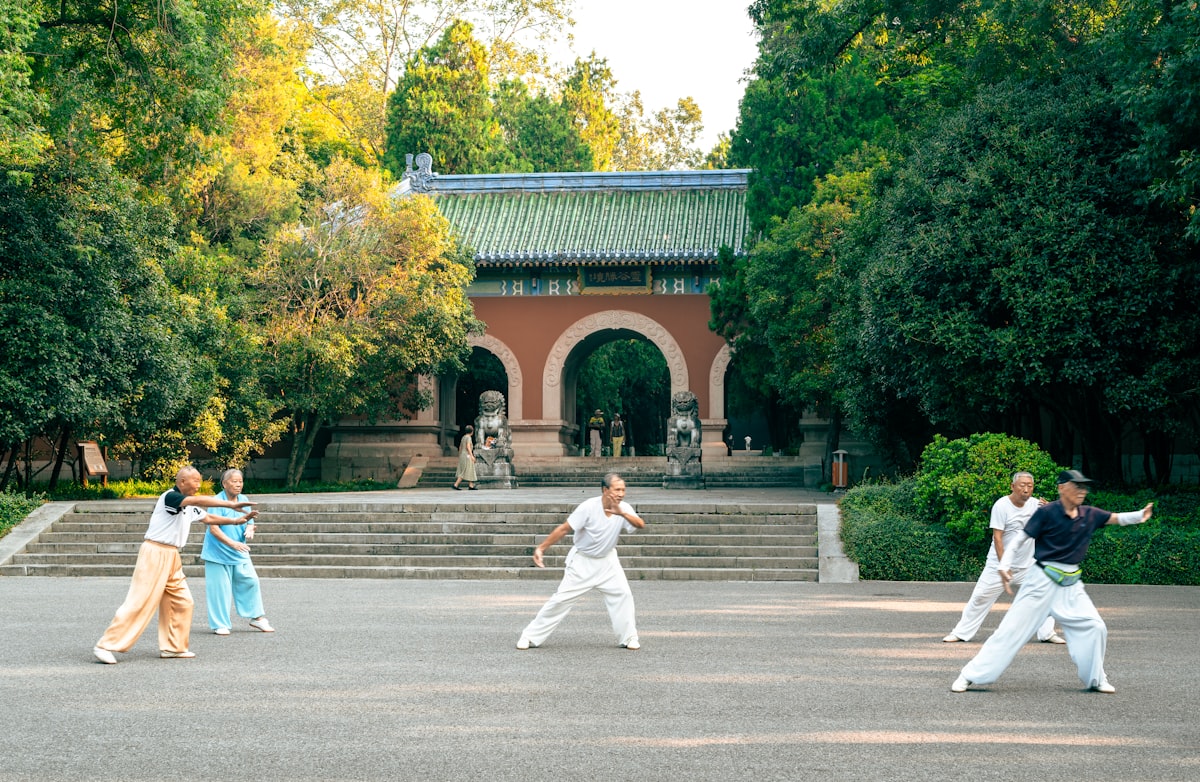 Group practicing Qi Gong movement outdoors